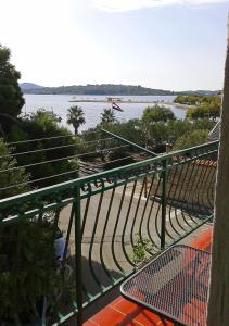 a view of the water from a balcony with a table at Apartments Anita in Srima
