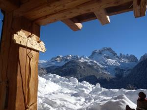 a view of a snow covered mountain from a cabin at Fogajard Lovely Chalet in Madonna di Campiglio
