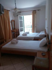 A bed or beds in a room at Irini Apartments Anaxos