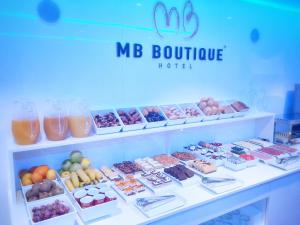 a display case with many different types of desserts at MB Boutique Hotel - Adults Recommended in Nerja