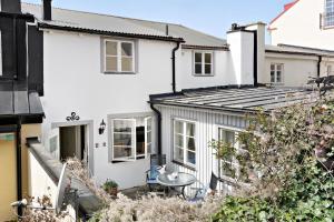 a white house with a table in front of it at Charming townhouse in Ystad