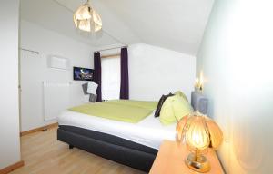 フィーホーフェンにあるAppartement Dürlingerのベッドとランプ付きのテーブルがある寝室 +5枚の写真