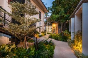 a courtyard of a building with plants and lights at The Privilege Boutique in Siem Reap