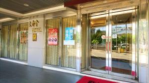 a facade of a building with glass doors at Metropolis Hotel in Taoyuan