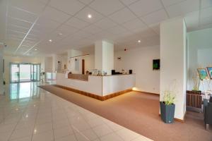 an empty lobby of a hospital with a reception counter at Hotel Metropol in Spišská Nová Ves