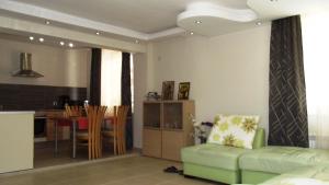 a living room with a green couch and a table at Villa Monche in Balchik