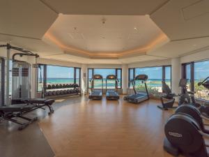 a gym with treadmills and exercise equipment in a building at Sheraton Okinawa Sunmarina Resort in Onna