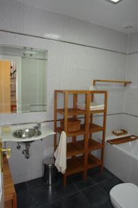 a bathroom with a sink and a toilet and a mirror at Clemens in Málaga
