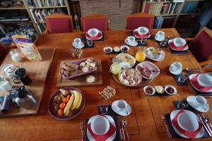 a wooden table with breakfast foods on it at The Silent Picket in Martinpuich
