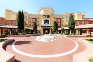 a large building with a clock on the side of it at Iberostar Málaga Playa in Torrox Costa