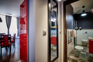 un bagno con porta rossa e una sala da pranzo di Apartamenty Kowary - Na Kowarskiej Starówce a Kowary