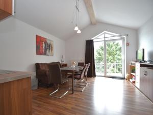 a kitchen and dining room with a table and chairs at Beautiful Apartment in Willingen with a Balcony in Willingen