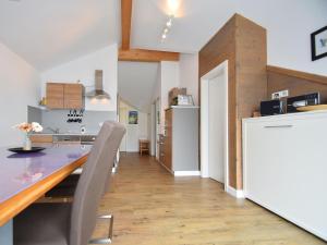 a kitchen with a table and a refrigerator at Modern Apartment in Willingen near Ski Lift in Willingen