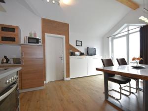 cocina y comedor con mesa y sillas en 2 separate flats with balcony on the ski slope, en Willingen