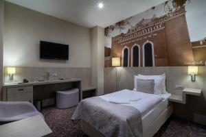 Postel nebo postele na pokoji v ubytování Košice Hotel