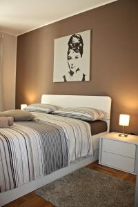 a bedroom with a bed with a black and white picture at Apartment Magnolia in Mušalež