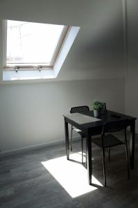 a table and chairs in a room with a window at Lisbon Beach Apartments 6 in Costa da Caparica