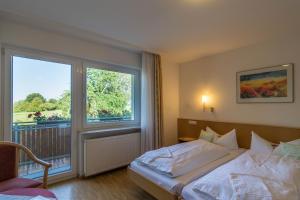Un dormitorio con una cama y una ventana grande. en Haus am Blauenbach, en Schliengen