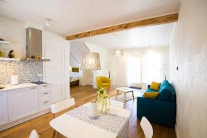 a living room with a blue couch and a table at Haapsalu Old Town Apartments in Haapsalu