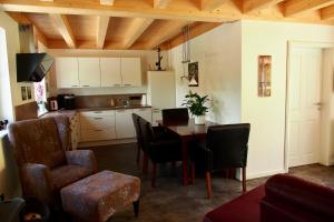 a kitchen and dining room with a table and chairs at Ferienwohnung Almflair Chalet in Thiersee