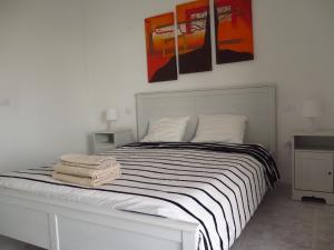 a bedroom with a bed with two towels on it at Casa Mi Lanzarote in Playa Honda