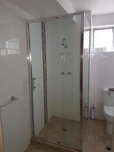 a glass shower in a bathroom with a toilet at Balcatta Sanctuary in Perth