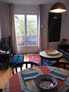 a living room with a table and chairs and a window at IBERIA 1 appartement T3 à 200 m de la plage avec parking privé in Hendaye +10 photos