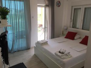 a bedroom with a bed with two towels and a window at Apartment Trebinje in Trebinje