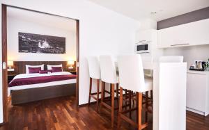 a bedroom with a bed and a table with white chairs at 12 Revay Hotel in Budapest