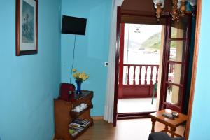 a living room with a door leading to a balcony at Hotel Imperial in Tazones