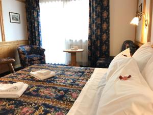 Postel nebo postele na pokoji v ubytování Hotel Alpi