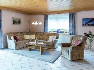 a living room with two couches and a table and chairs at Lovely Mansion in Lirstal with Terrace in Lirstal