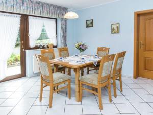 a dining room with a wooden table and chairs at Lovely Mansion in Lirstal with Terrace in Lirstal