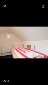 a bedroom with a bed with a striped blanket at Gracefield in Artane