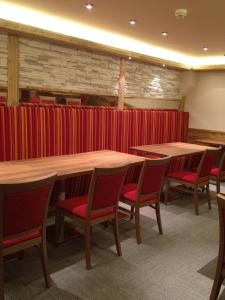 a conference room with tables and chairs and red curtains at Prinzhotel Rothenburg in Rothenburg ob der Tauber