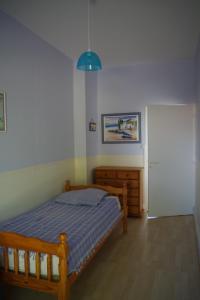 a bedroom with a bed and a blue light at Maison de famille Jo et Juliette in Suin