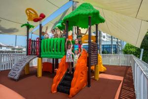 a group of children playing on a playground at Pavlo Napa Beach Hotel in Ayia Napa