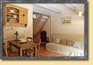 a living room with a couch and a table at Aubergerie in Sauzon