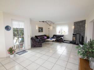 a living room with a couch and a table at Holiday home in Hesse with large garden in Buchenberg