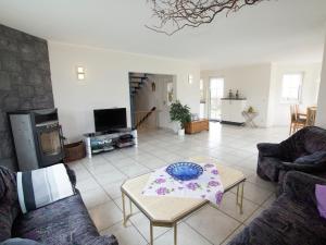 a living room with two couches and a table at Holiday home in Hesse with large garden in Buchenberg