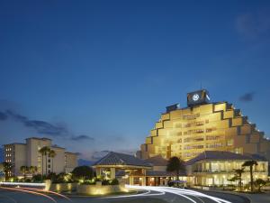 a building with a clock on the top of it at Sheraton Okinawa Sunmarina Resort in Onna