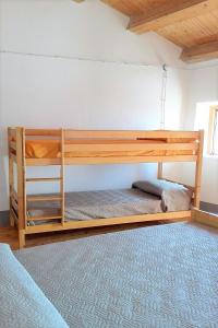 a bunk bed in a room with a bed at Case Rurali Pentedattilo in Pentedattilo