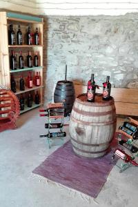 a room with two large wine barrels and bottles at Case Rurali Pentedattilo in Pentedattilo
