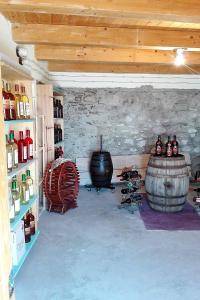 a wine cellar with a bunch of bottles and barrels at Case Rurali Pentedattilo in Pentedattilo