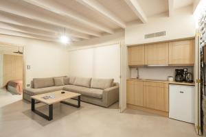 a living room with a couch and a table at ARMONIA 1 & 2 in Myrina