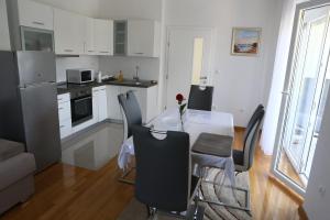 a kitchen and dining room with a table and chairs at Apartments Edita in Zadar