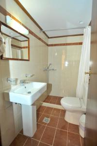 a bathroom with a sink and a toilet at Hotel Byzantine in Rethymno
