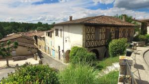 an old building in a village with a street at VVF Gers Gascogne in Mauvezin