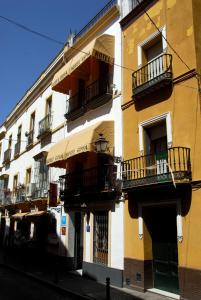un edificio con balcones al lado de una calle en Hotel Goya, en Sevilla