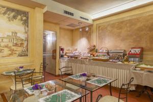 a restaurant with two tables and a counter at Hotel Marco Polo in Verona